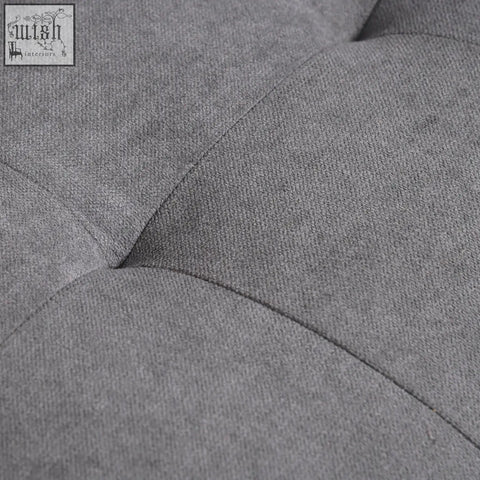 Gray tufted fabric seater sofa with stitched button details and eucalyptus wood legs ensure hidden storage comfort