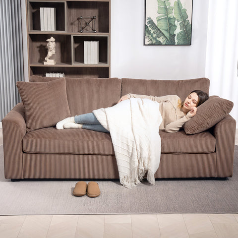 Brown corduroy 3 seater sofa with spring pack and matching scatter cushions draped with white textured throw blanket