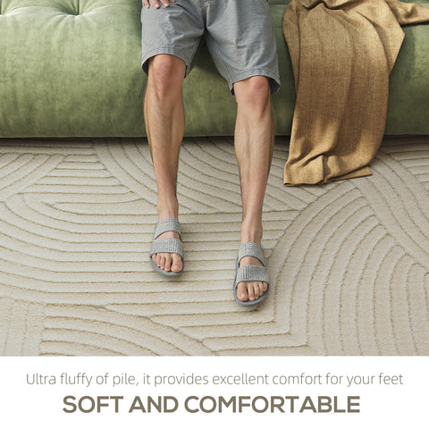 Gray ultra fluffy slide sandals with woven texture and cushioned soles next to a cream thick plush homcom geometric rug
