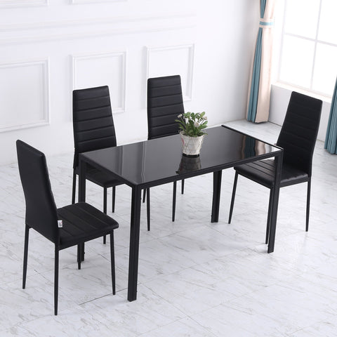 Black tempered glass dining table with metal legs and four matching black upholstered chairs for dinner parties