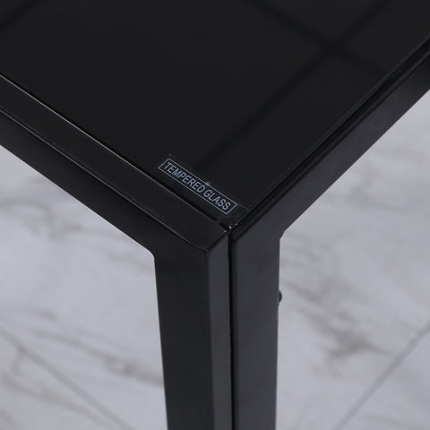 Black tempered glass dining table with sleek edges and glossy finish perfect for dinner parties and modern kitchens