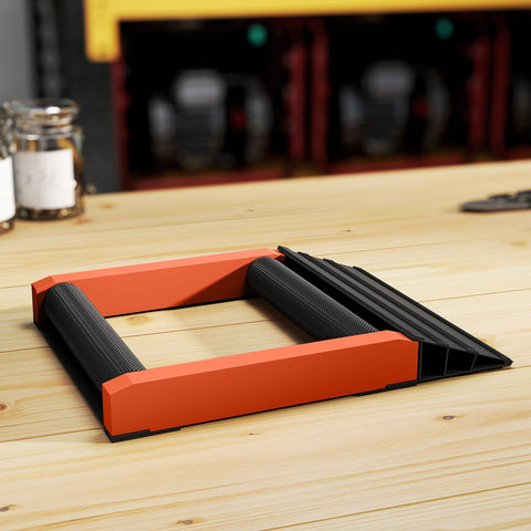 Orange and black plastic garage door opener ramp with textured grip on aluminium alloy frame for motorcycle wheel cleaning