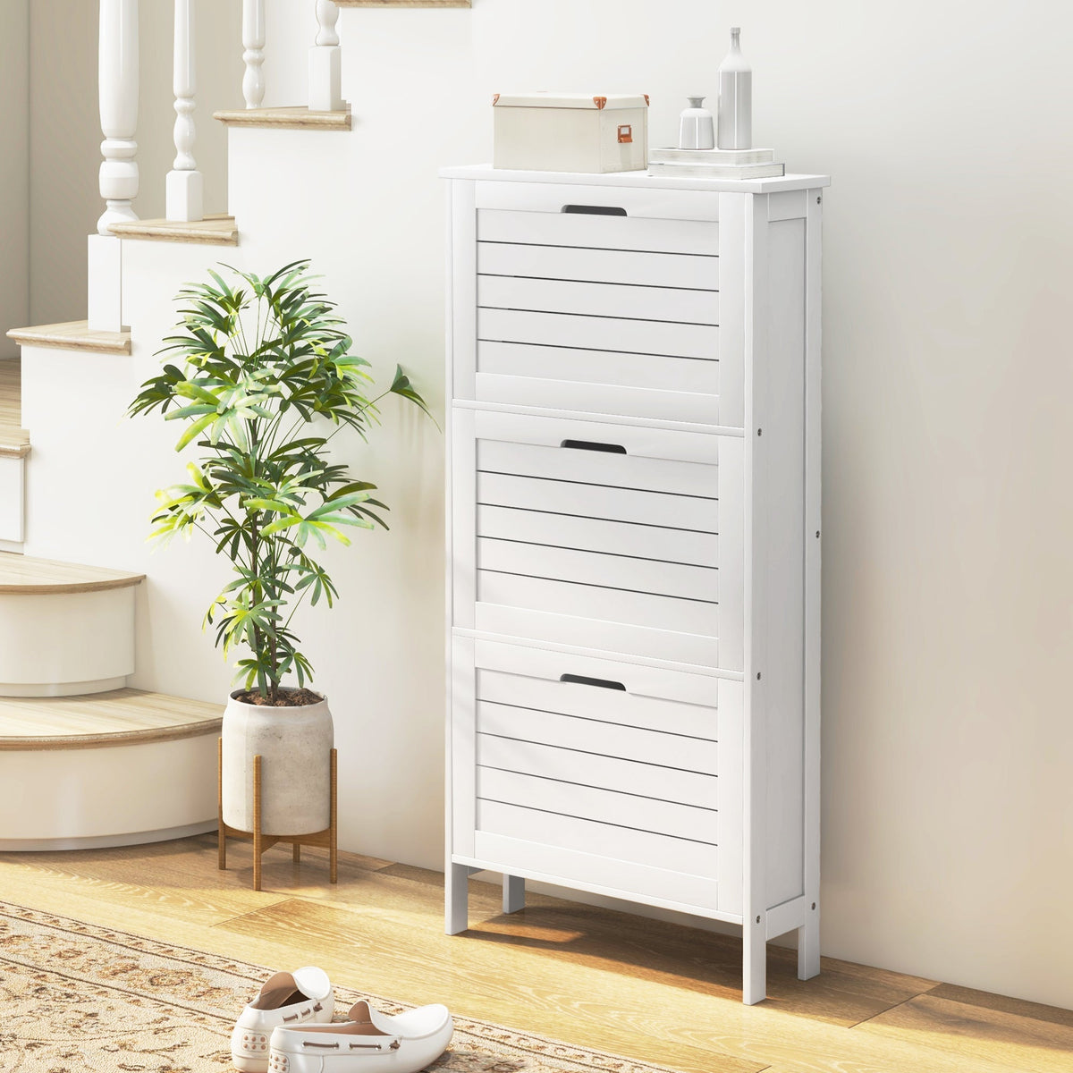 White wooden shoe storage cabinet with three slatted flip drawers perfect for narrow shoe storage and organization