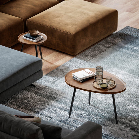 Oval wooden coffee table with sleek matte black metal legs and chestnut wood effect for living room or office use