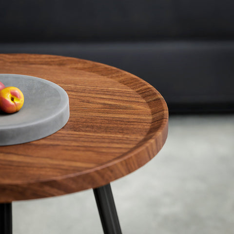 Round wooden coffee table with sleek matte black metal legs and chestnut wood effect perfect for living room use