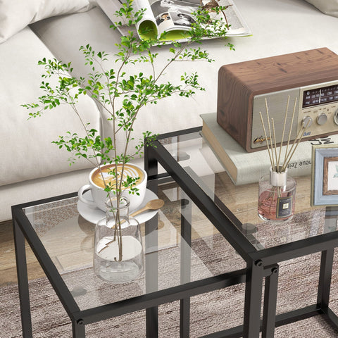 Black metal-framed nesting table set with tempered glass top perfect for living room or bedroom use
