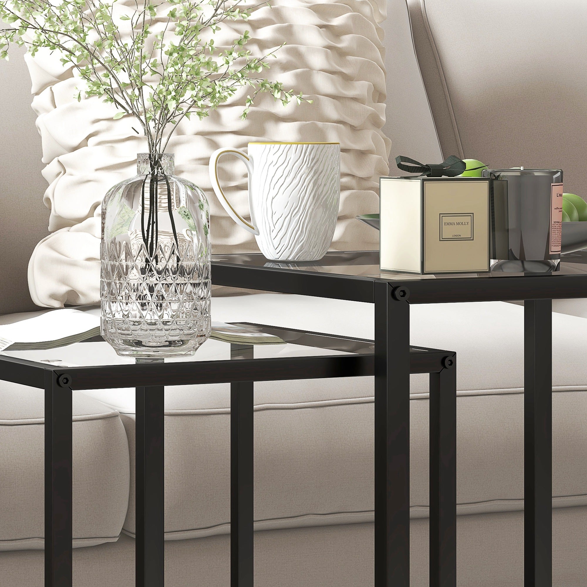 Clear glass vase with intricate cut crystal patterns placed on homcom black steel frame nesting tables with tempered glass top for living room