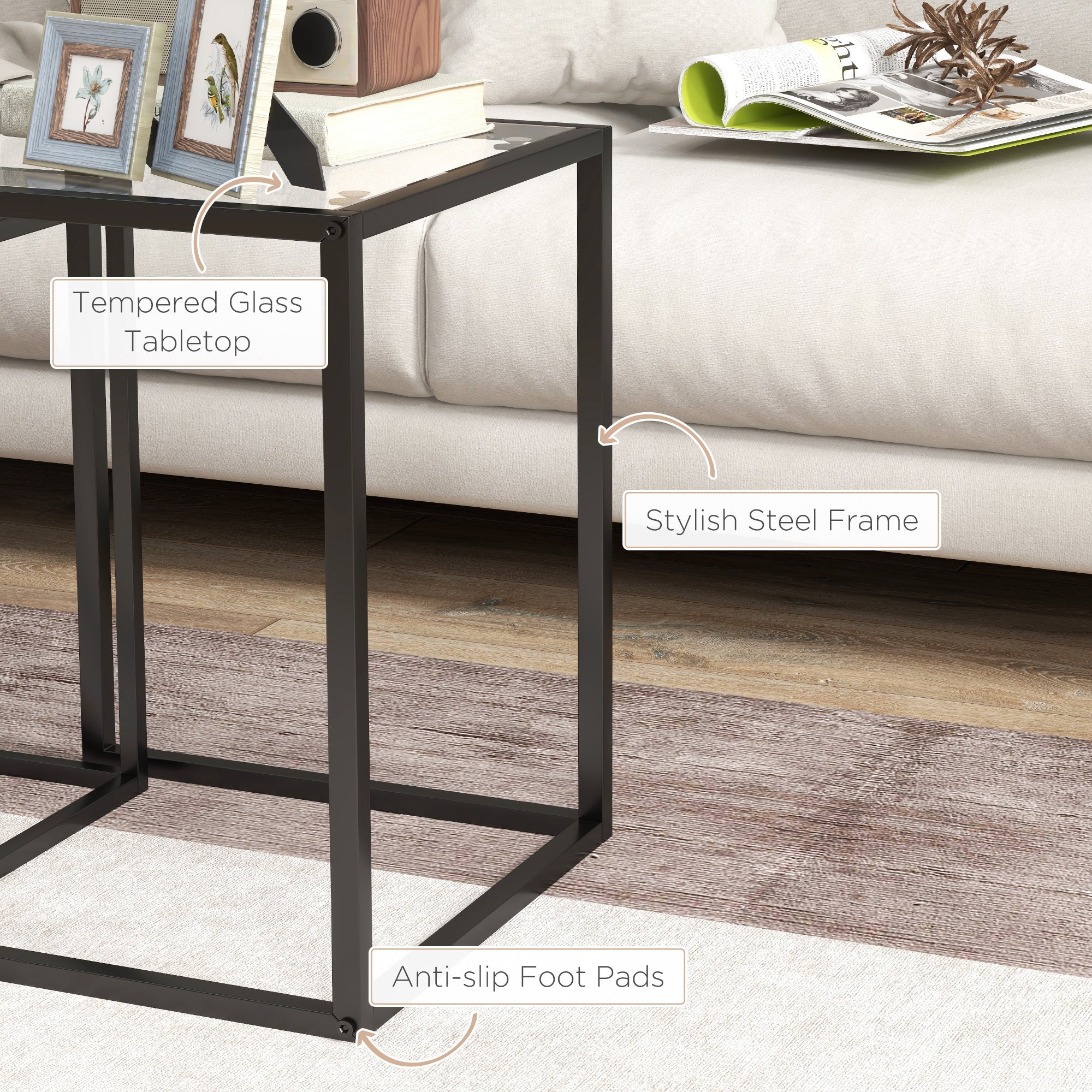 Black tempered glass tabletop supported by steel frame with anti slip pads in HOMCOM nesting table set for living room