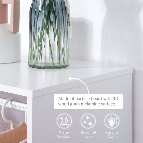 A tall blue green glass vase with vertical ridges and a white ribbon next to a white open wardrobe with aluminium hanging rail and particle board shelves