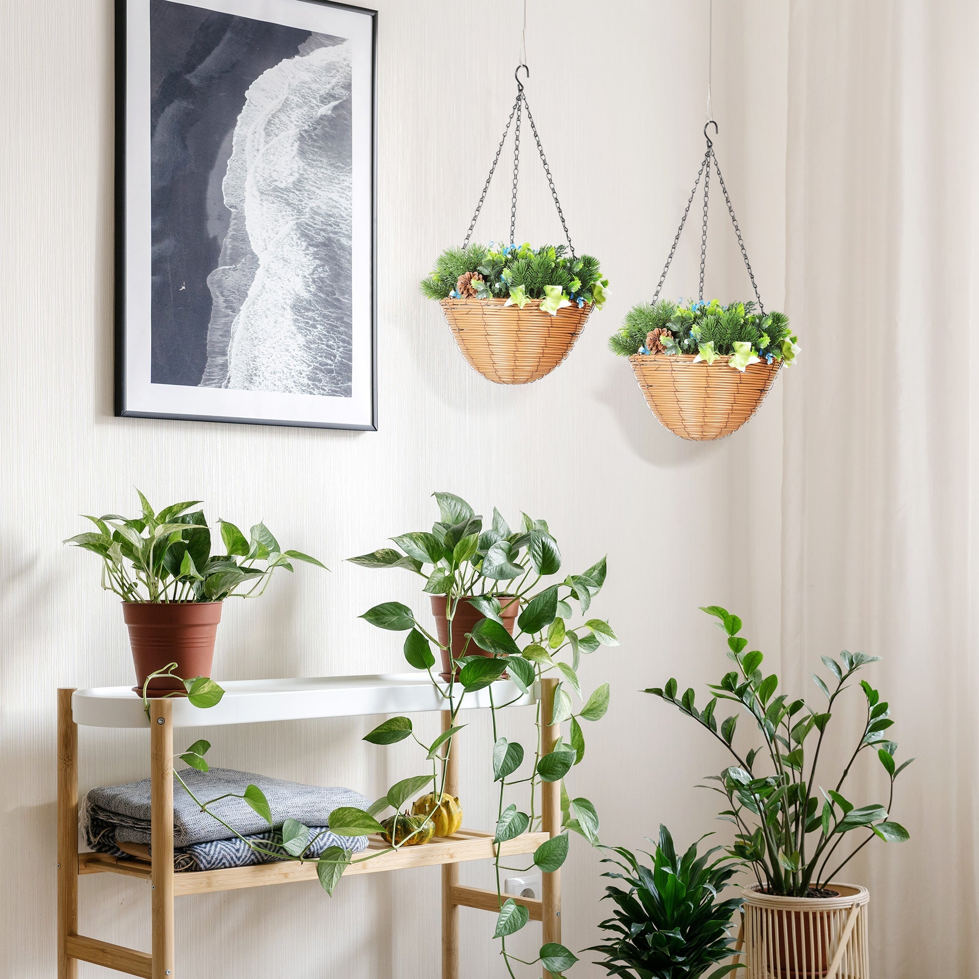Woven wicker hanging plant baskets with green artificial flowers and pinecones perfect for office decor