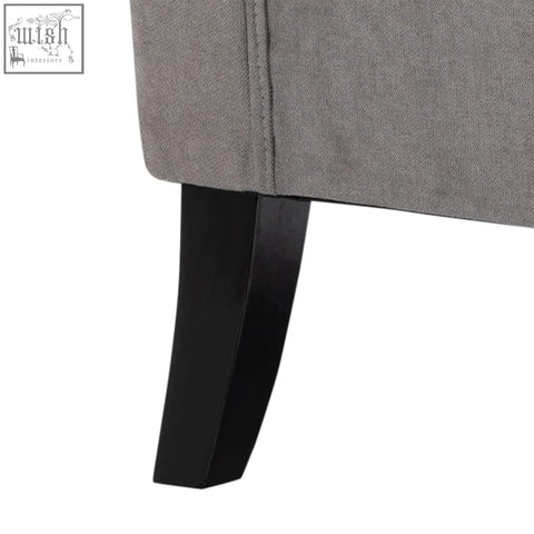 Gray upholstered leg of homcom retro accent chair with button tufted design and sleek curved black wood base