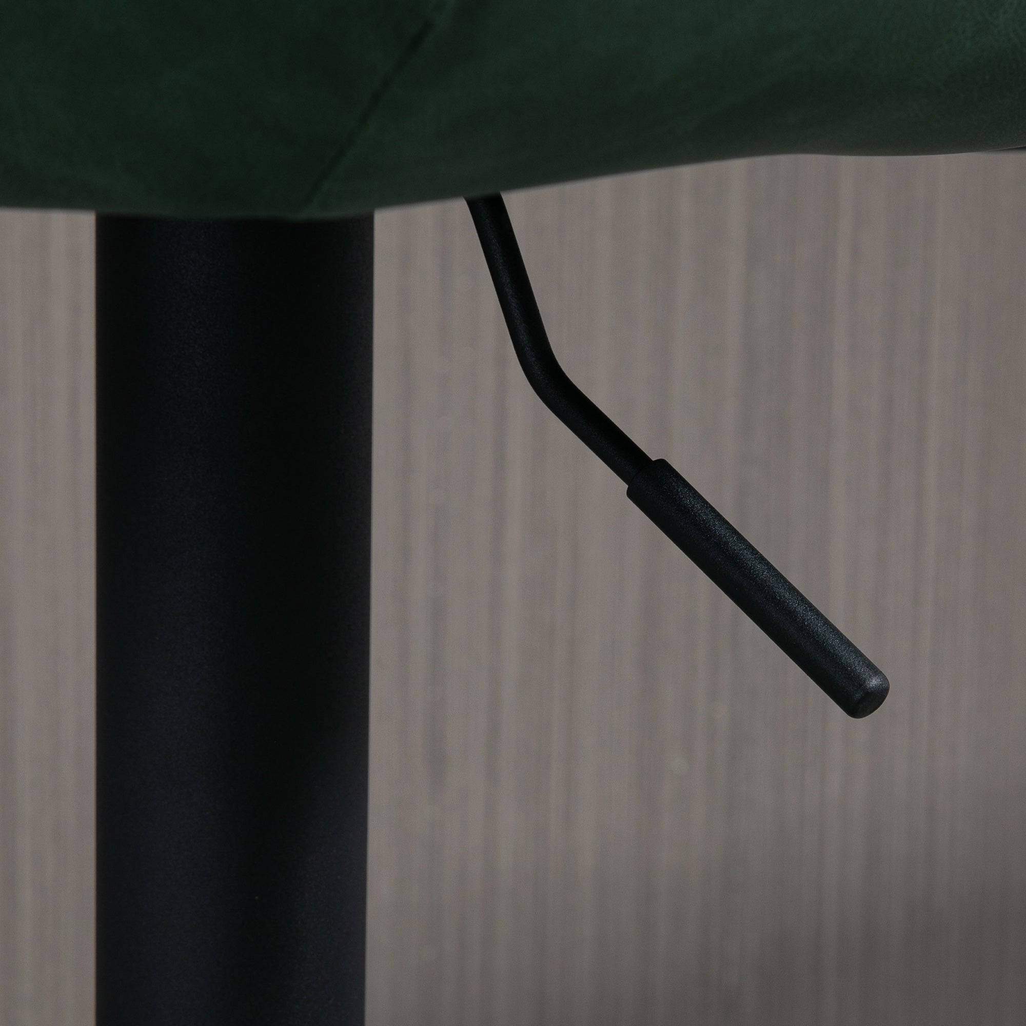 Black textured plastic lever attached to dark green faux leather upholstery on homcom adjustable bar stool seat