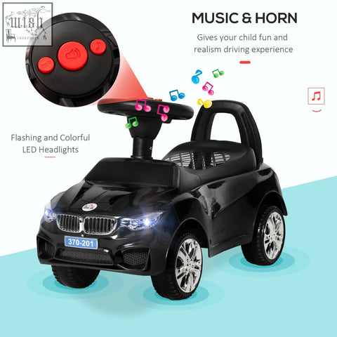 Black bmw-themed ride on car with chrome wheels illuminated headlights steering wheel high backrest and under-seat storage