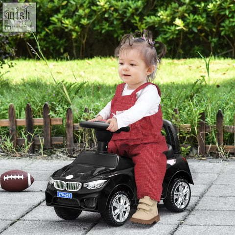 Black plastic homcom ride on car for toddlers with steering wheel, high backrest, and under-seat storage