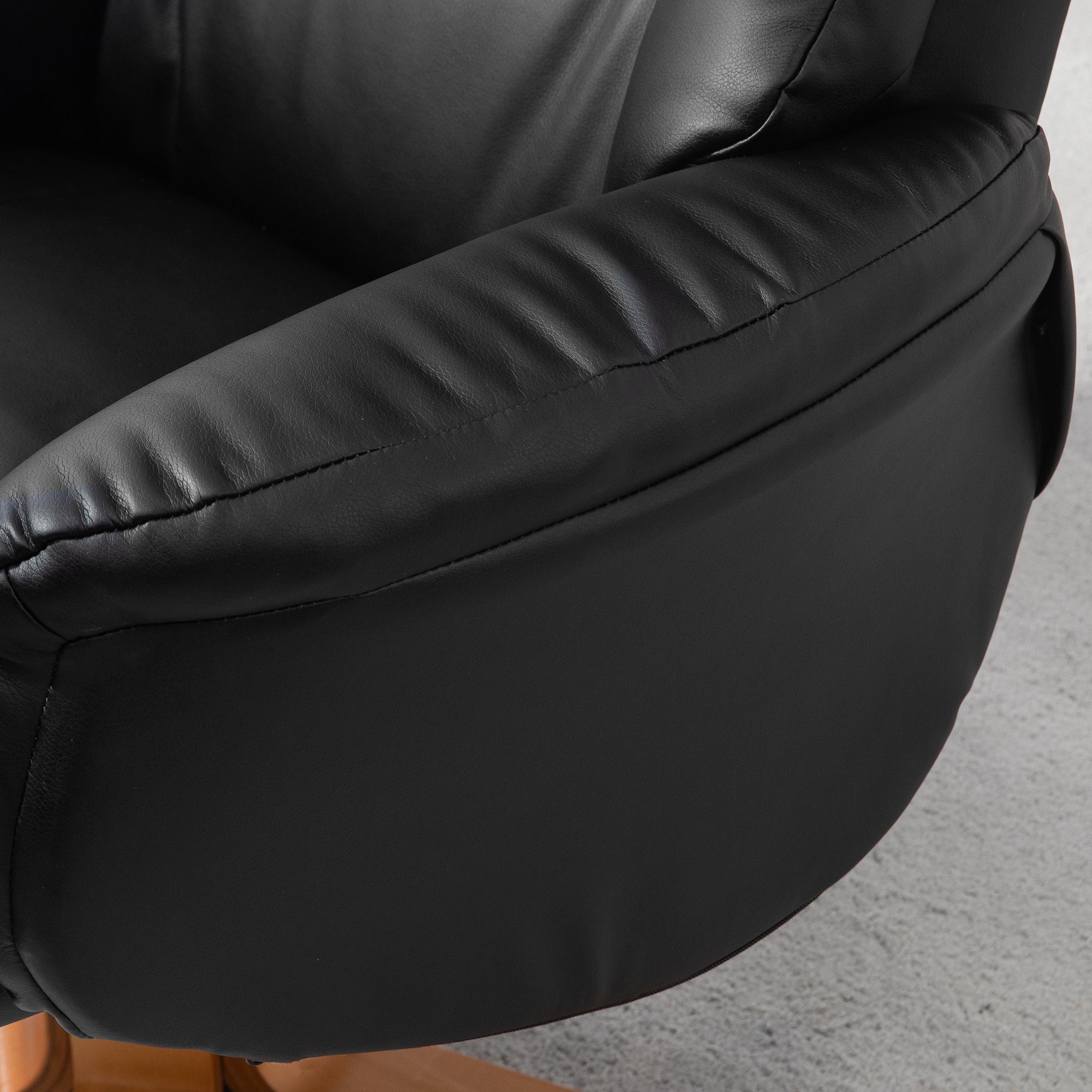 Black leather armrest with stitched detailing on homcom recliner chair with easy-to-clean pu leather and gentle rocking motion