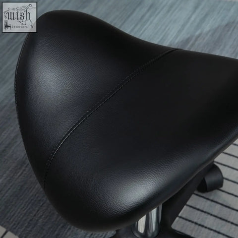 Black leather-like padded seat of homcom saddle stool with steel frame for salon spa and tattoo use