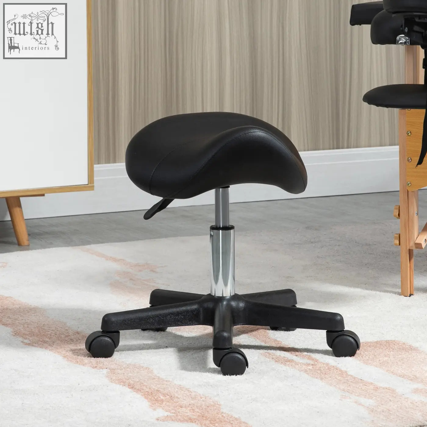Black homcom saddle stool with padded seat, steel frame, chrome base, and casters for salon and spa use