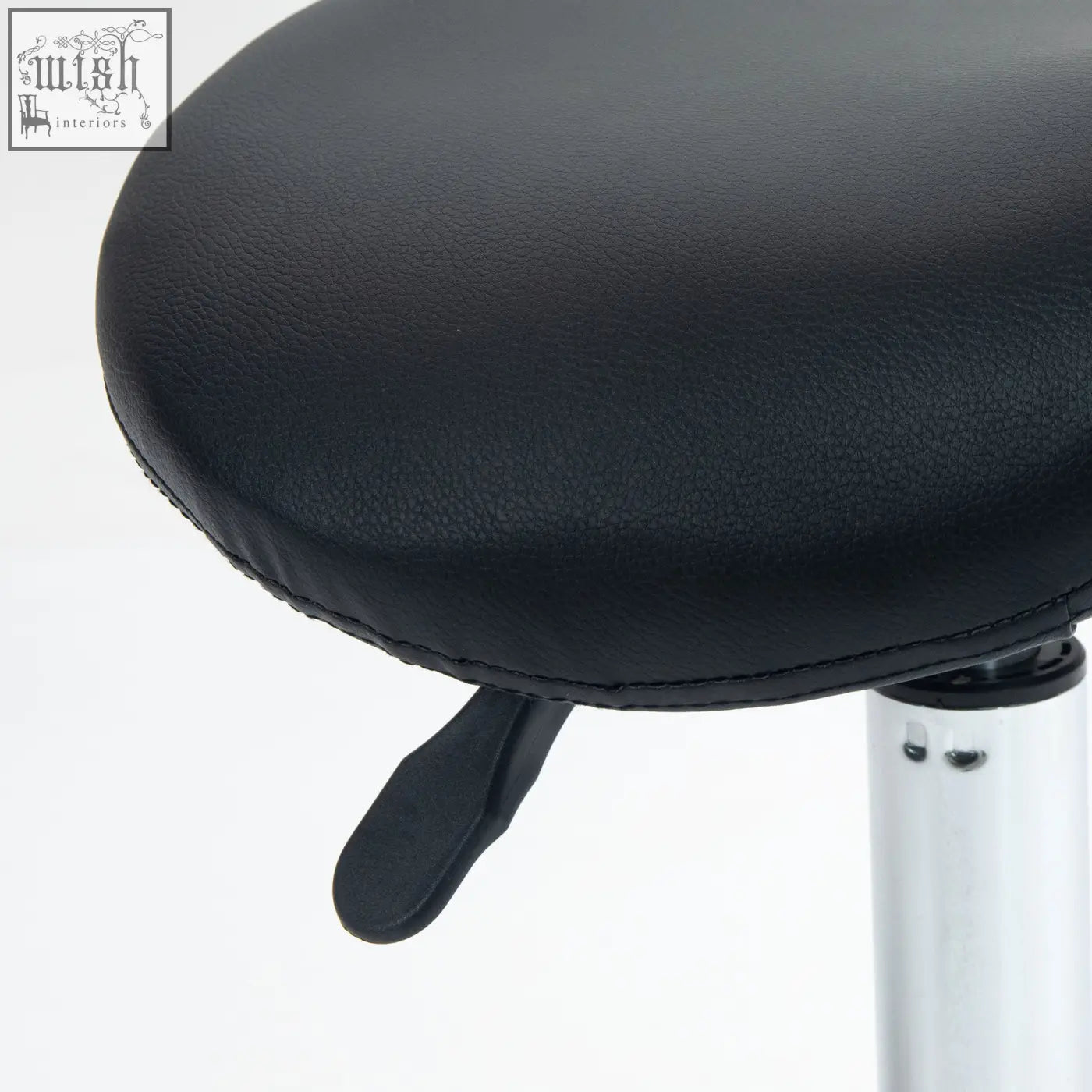 Black leatherette ergonomic saddle stool with silver metal base and height lever for salon and clinic use