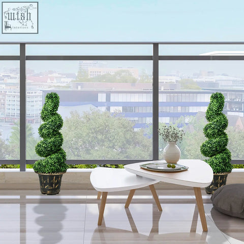 Two homcom spiral boxwood trees in dark pots flank a white nesting coffee table for indoor outdoor decor