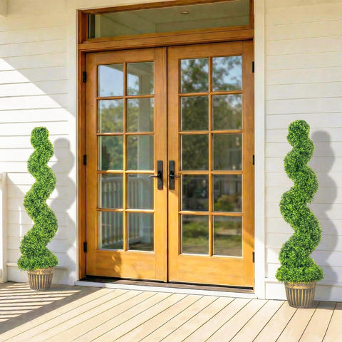 Pair of light oak french doors with glass panes and black hardware beside homcom spiral boxwood trees in pots