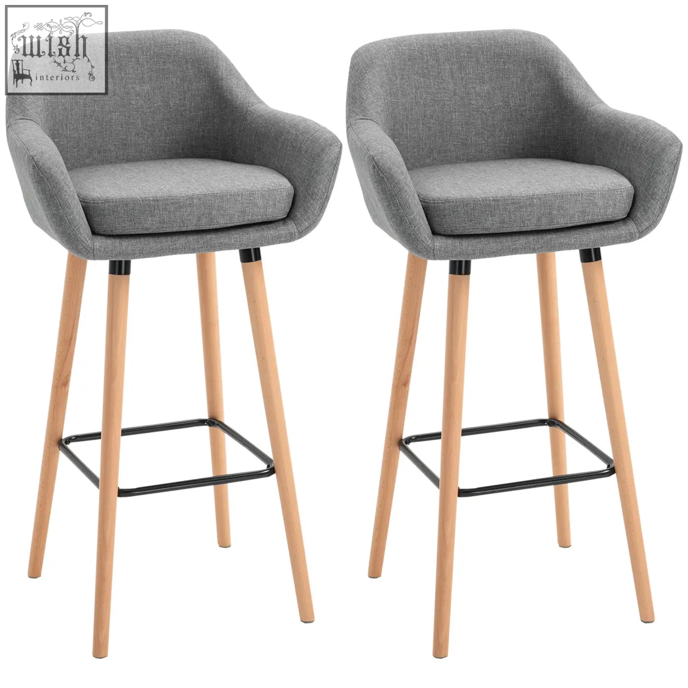 Gray upholstered bar stools with solid wood legs and black metal footrests featuring linen upholstery for dining room use