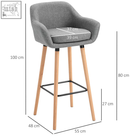 Gray upholstered bar stools with solid wood legs and black metal footrest perfect for dining or living room seating