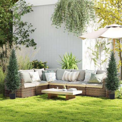 Woven rattan outdoor sectional sofa with beige cushions and patterned pillows next to a uv-resistant artificial cypress tree in nursery pot