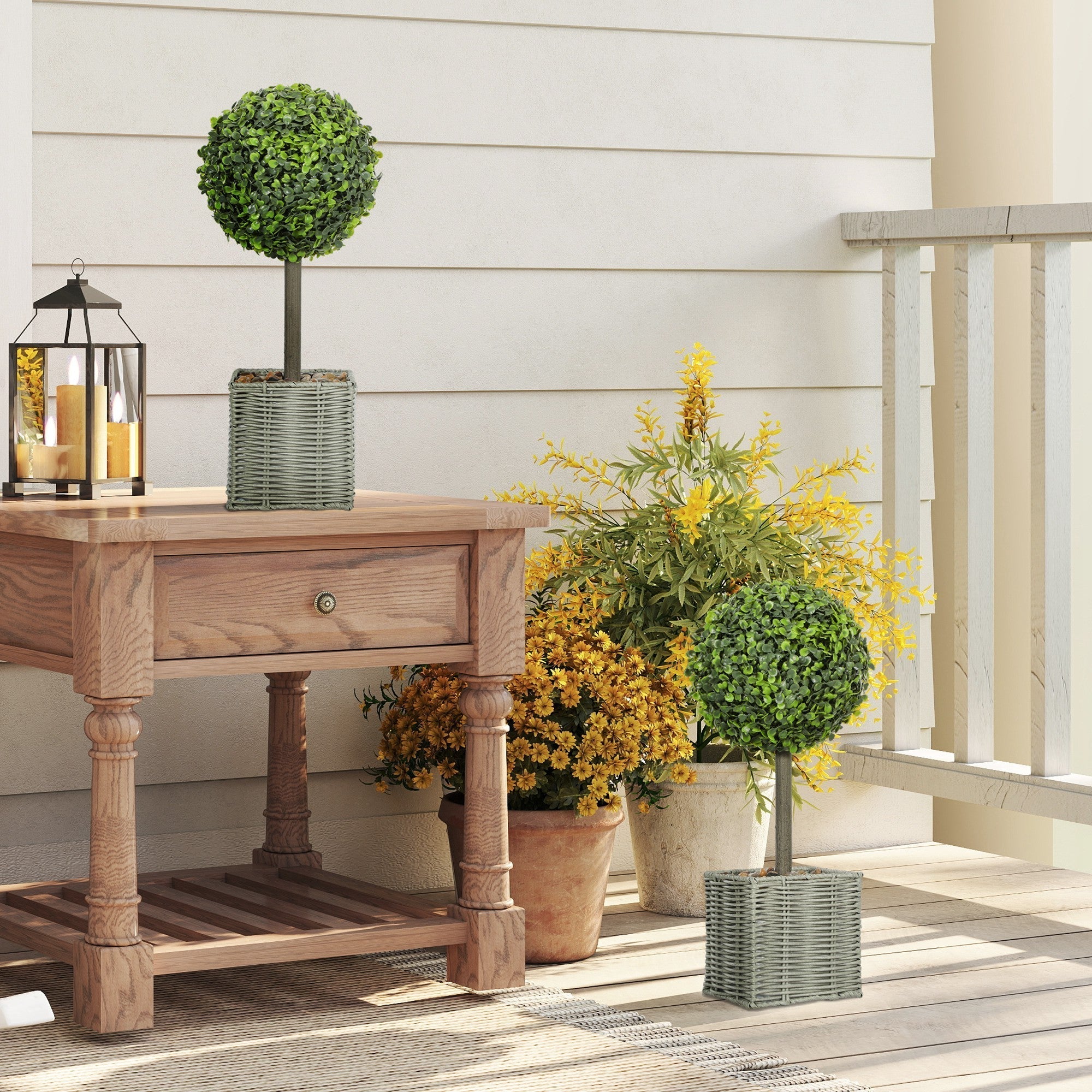 Green round faux boxwood topiary tree in a woven plastic gray wicker pot fully assembled for home or office decor
