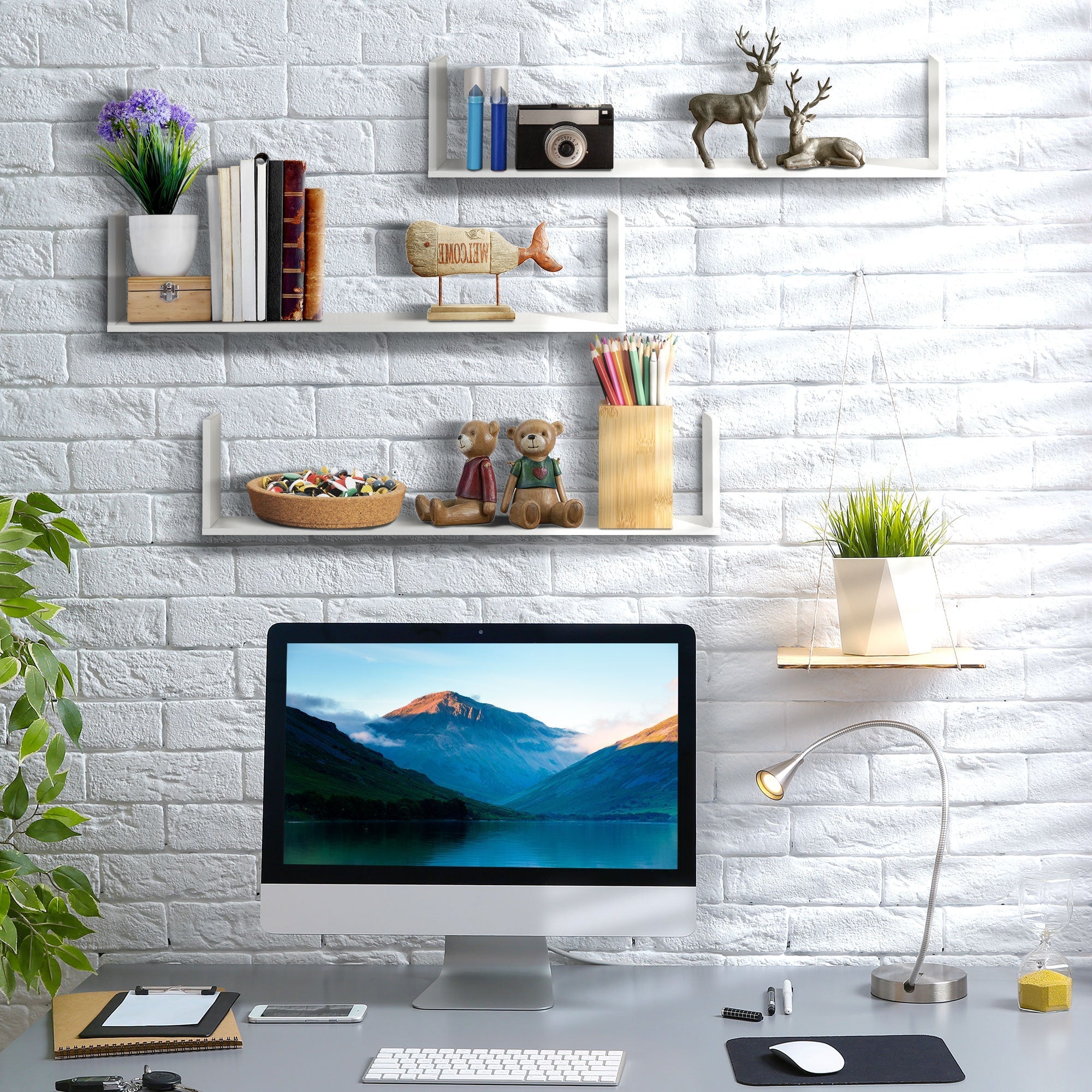 White minimalist wooden U-shaped floating shelves mounted on brick wall to save floor space in living room