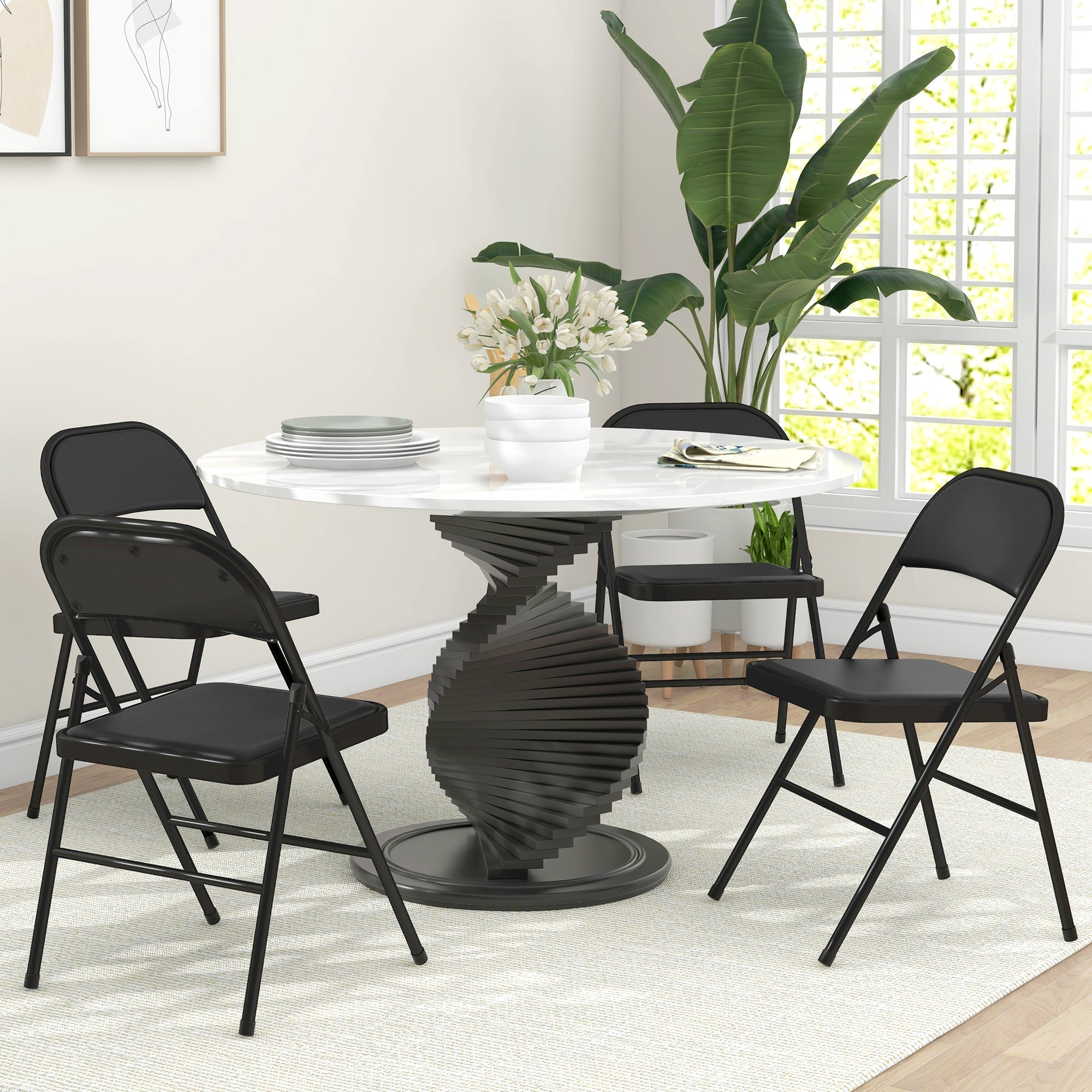 Black metal folding chair with padded seat and backrest featuring sturdy steel frames from HOMCOM set of four folding chairs
