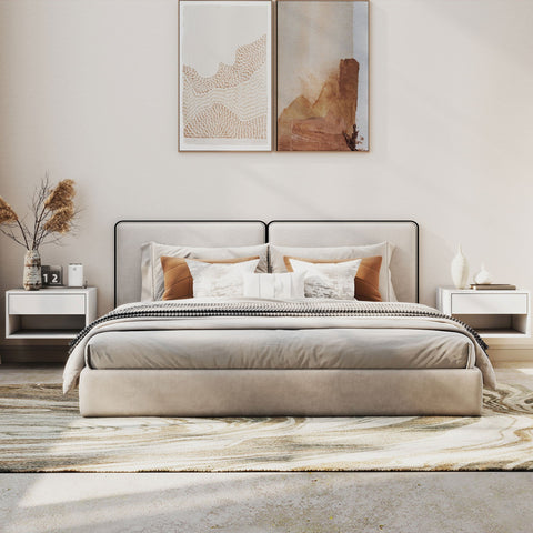 Beige upholstered bed with black frame and layered pillows next to white particle board bedside tables with open shelf