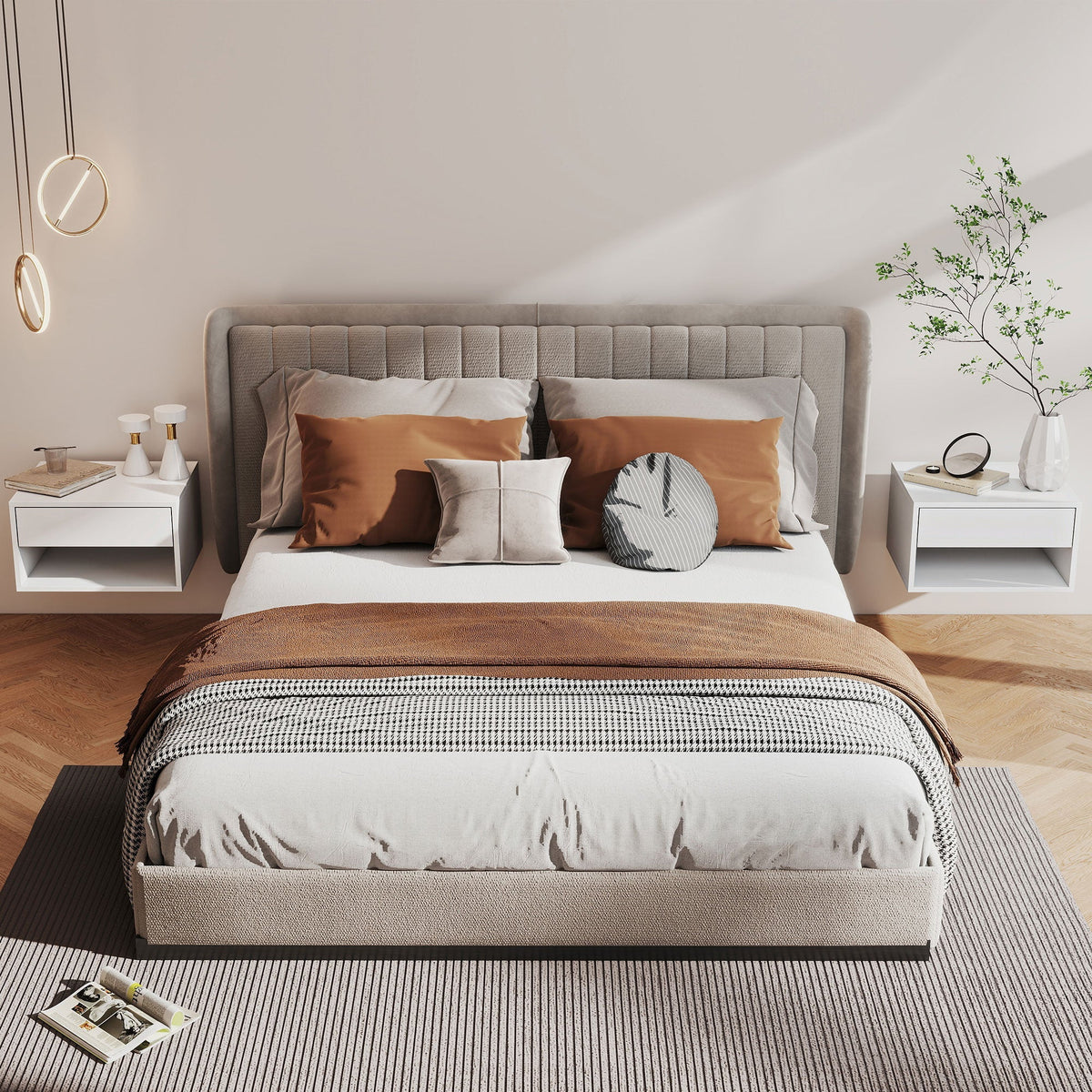Beige upholstered bed with tufted headboard and footboard layered with white bedding next to white particle board bedside tables with open shelf