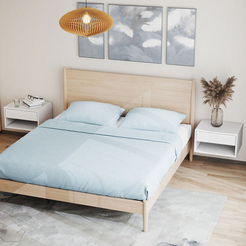 Light wood bed with light blue bedding next to homcom white particle board bedside tables with open shelf