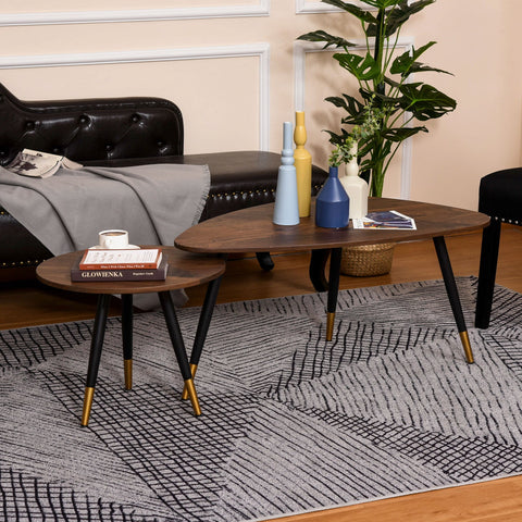 Mid-century modern oval coffee table set with dark walnut top and black legs with gold tips perfect as small or large table