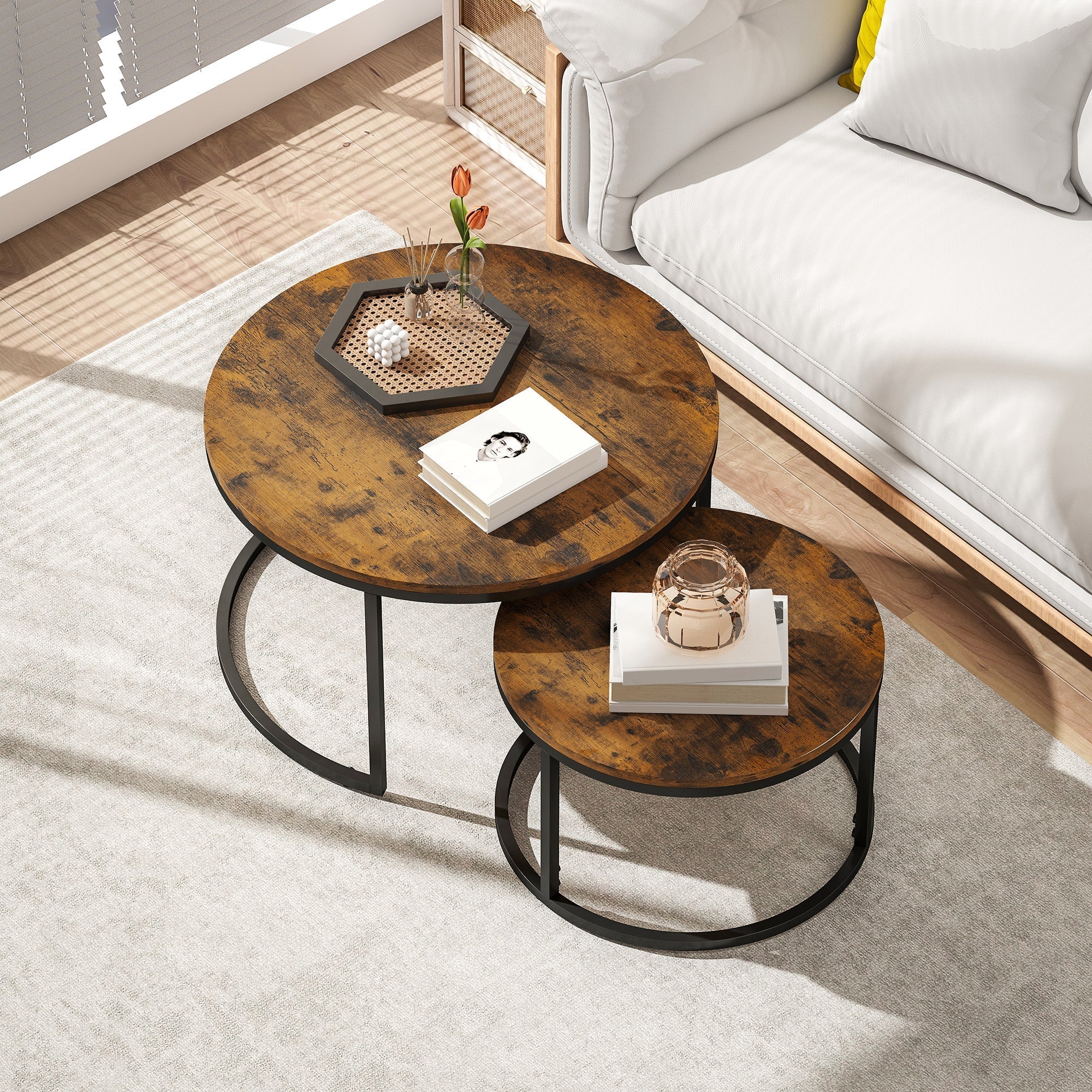 Rustic brown distressed wood top nesting coffee tables with black metal circular bases set by HOMCOM