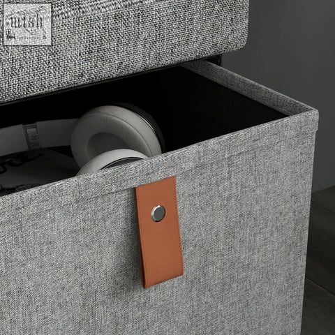 Gray textured fabric homcom shoe bench with tan leather strap and metallic button stores six shoe pairs neatly