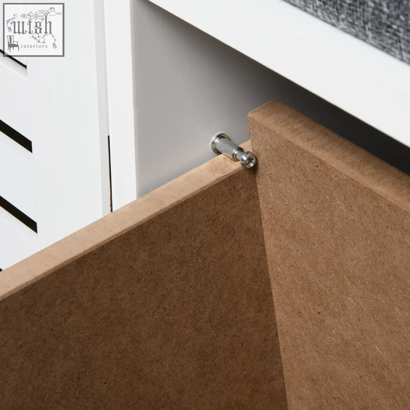 Silver-toned metal corner bracket securing brown particle board panels on homcom shoe storage bench with slatted doors