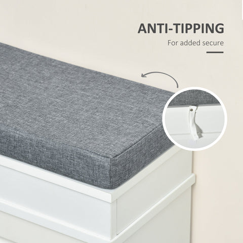 Gray textured fabric cushion with white anti-tip mechanism on white particle board shoe storage bench for entryway seating