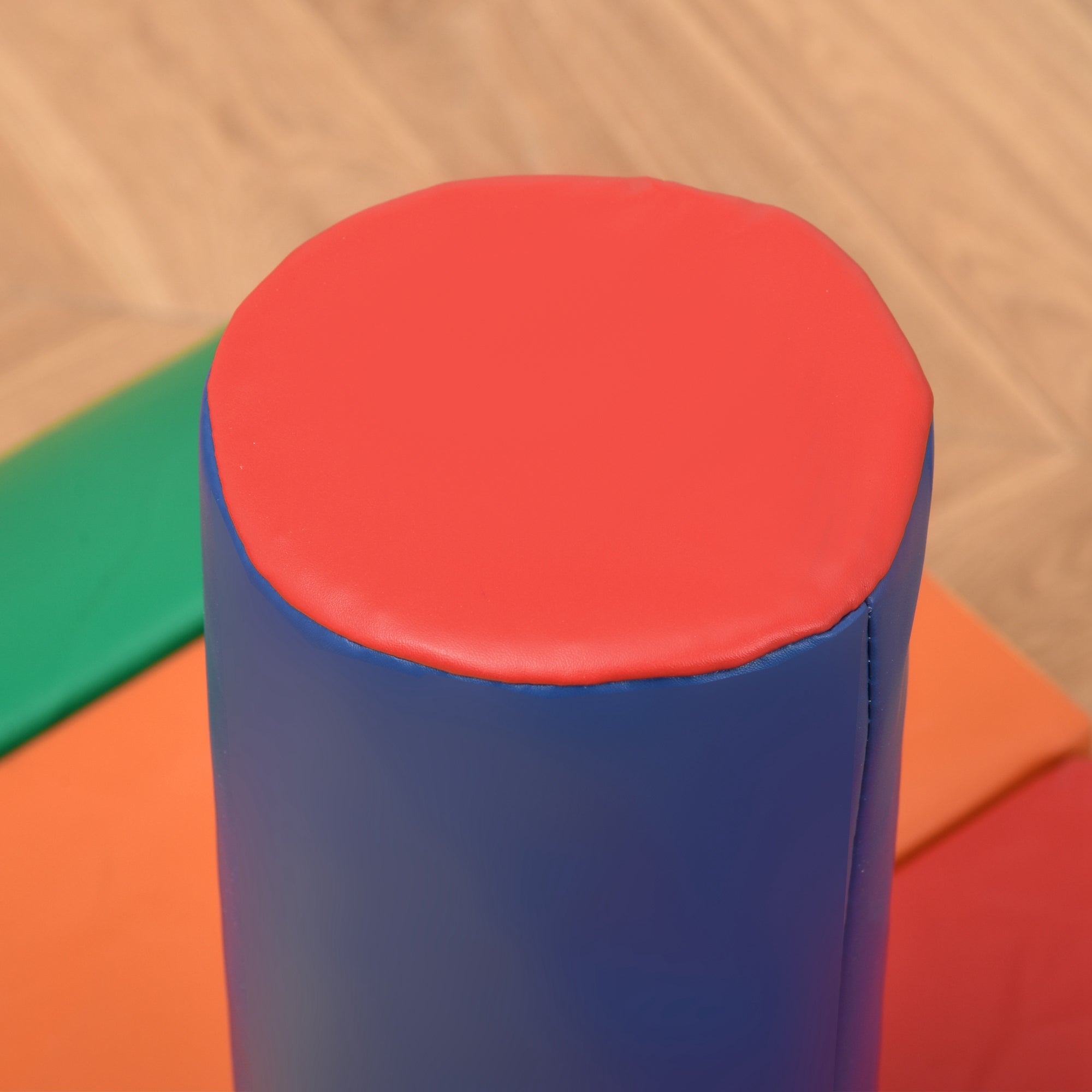 Red and blue cylindrical soft foam roller with smooth padded surface, part of homcom soft play set 20h x 40l toddler toy