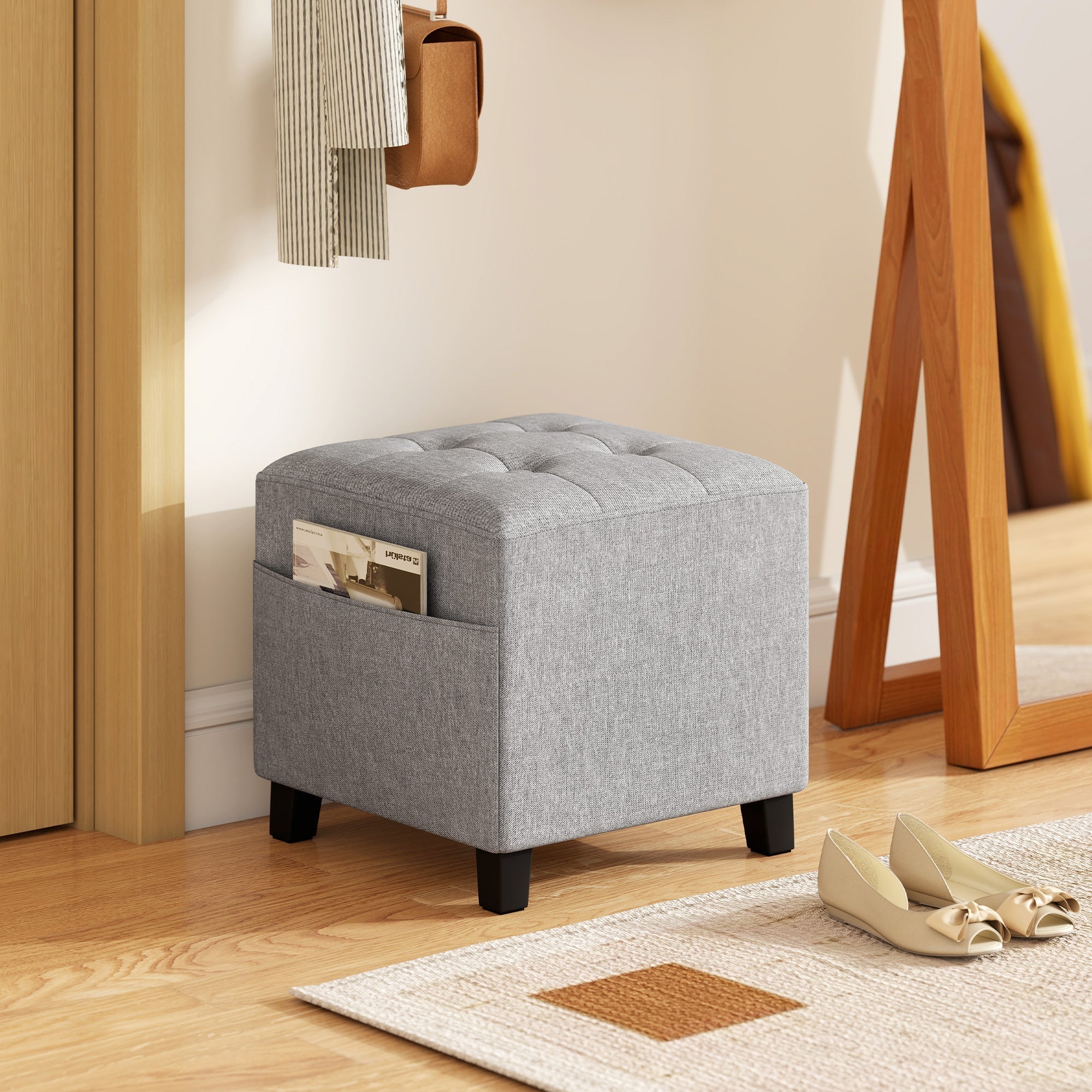 Gray tufted fabric HOMCOM square footstool with wood legs and side pocket holding magazines for living room use