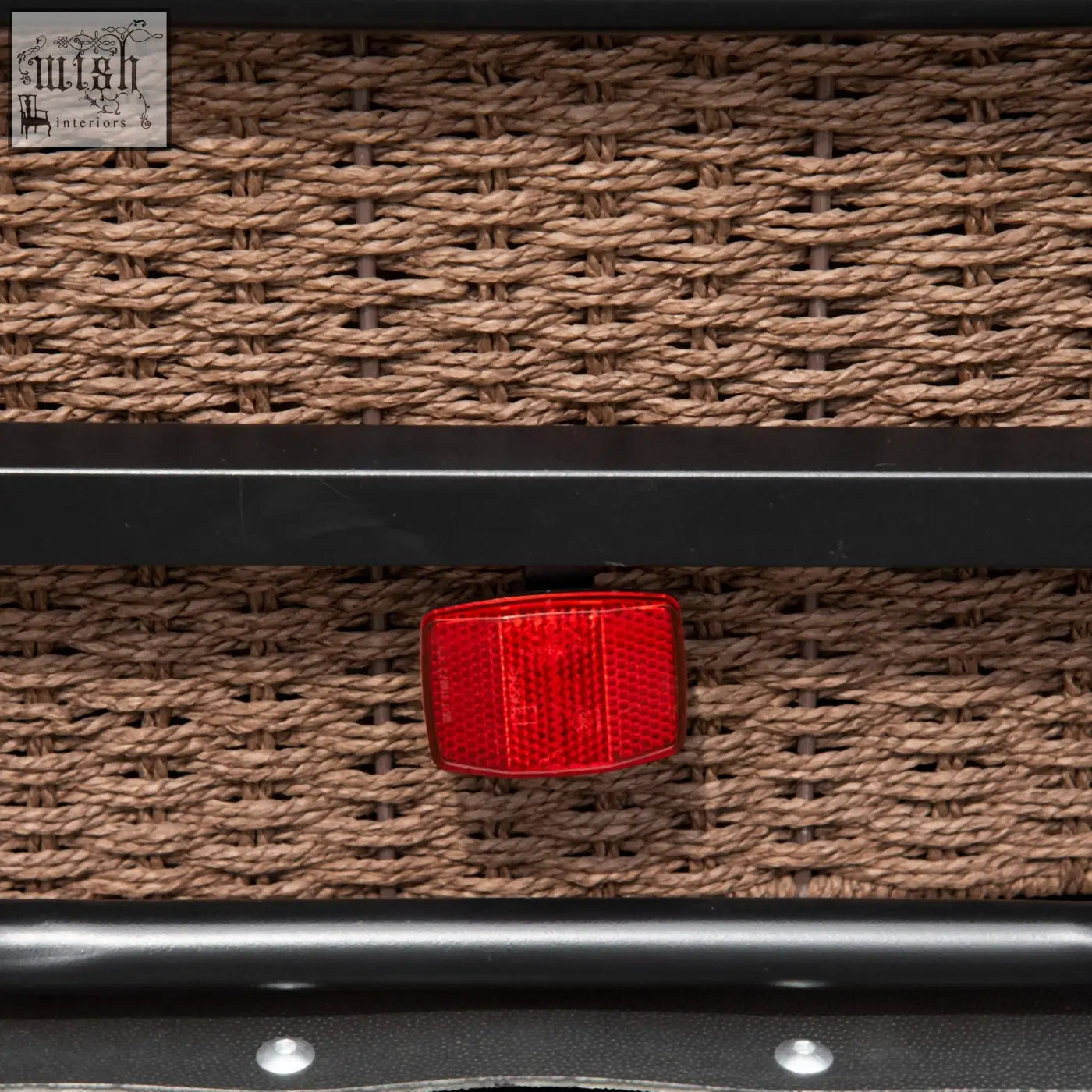 Red rectangular reflector on woven brown wicker showing back of homcom black steel bike trailer with triple safety and shock absorption