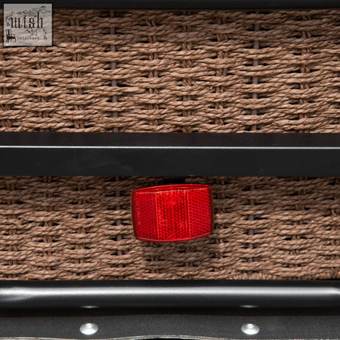 Red rectangular reflector on woven brown wicker showing back of homcom black steel bike trailer with triple safety and shock absorption