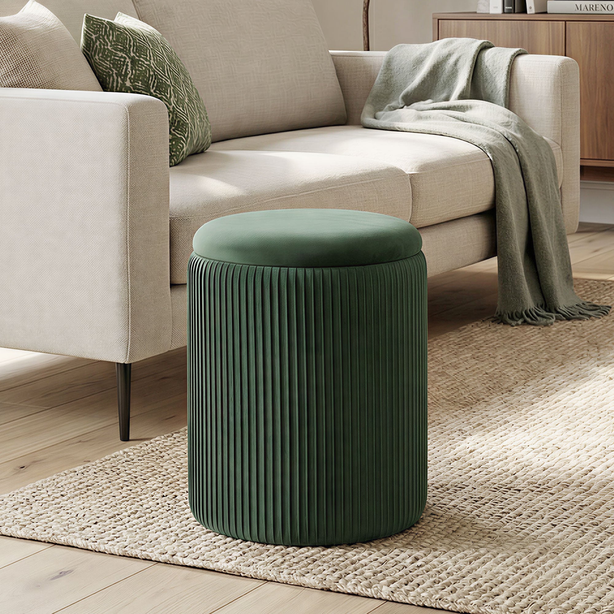Dark green velvet storage ottoman with vertical pleats and round cushioned top for living room or bedroom seating