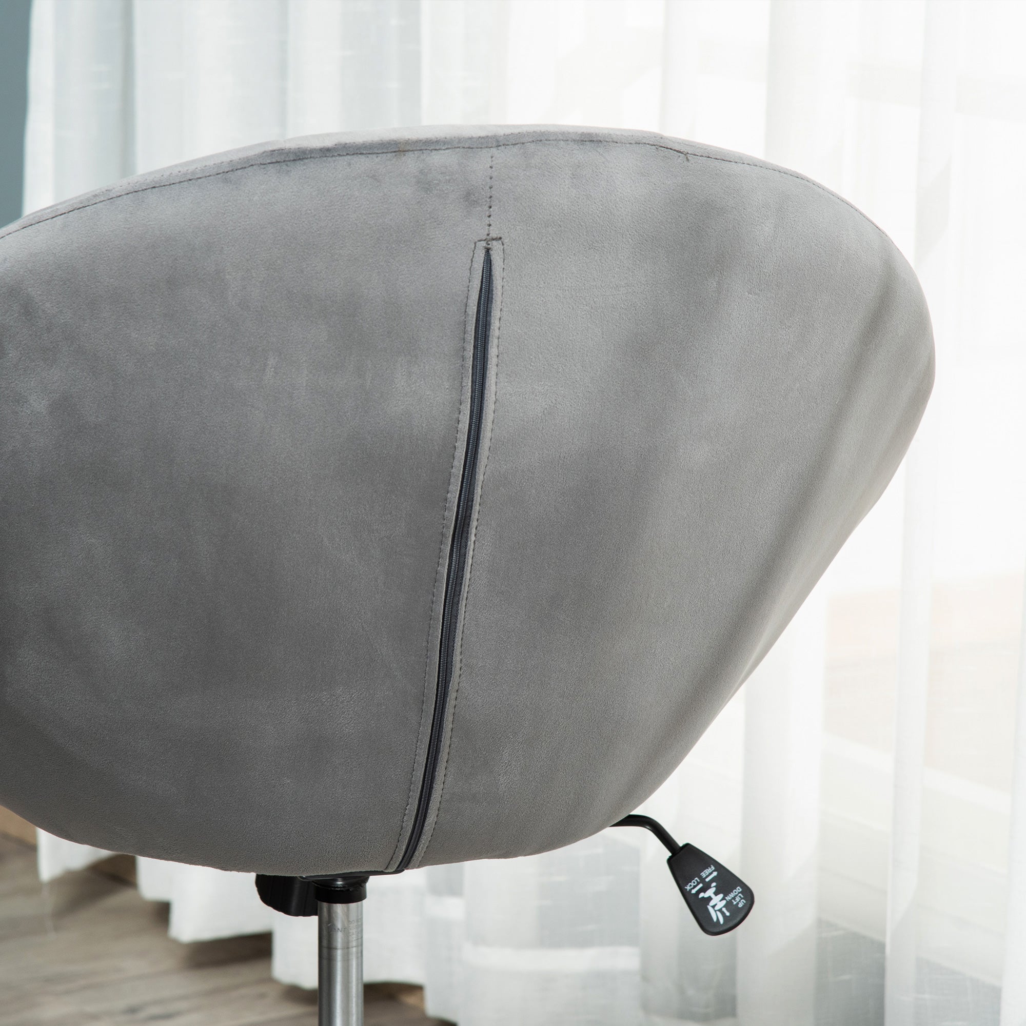 Gray velvet-feel upholstered dressing stool with button tufting and zipper detail on the backrest for makeup use