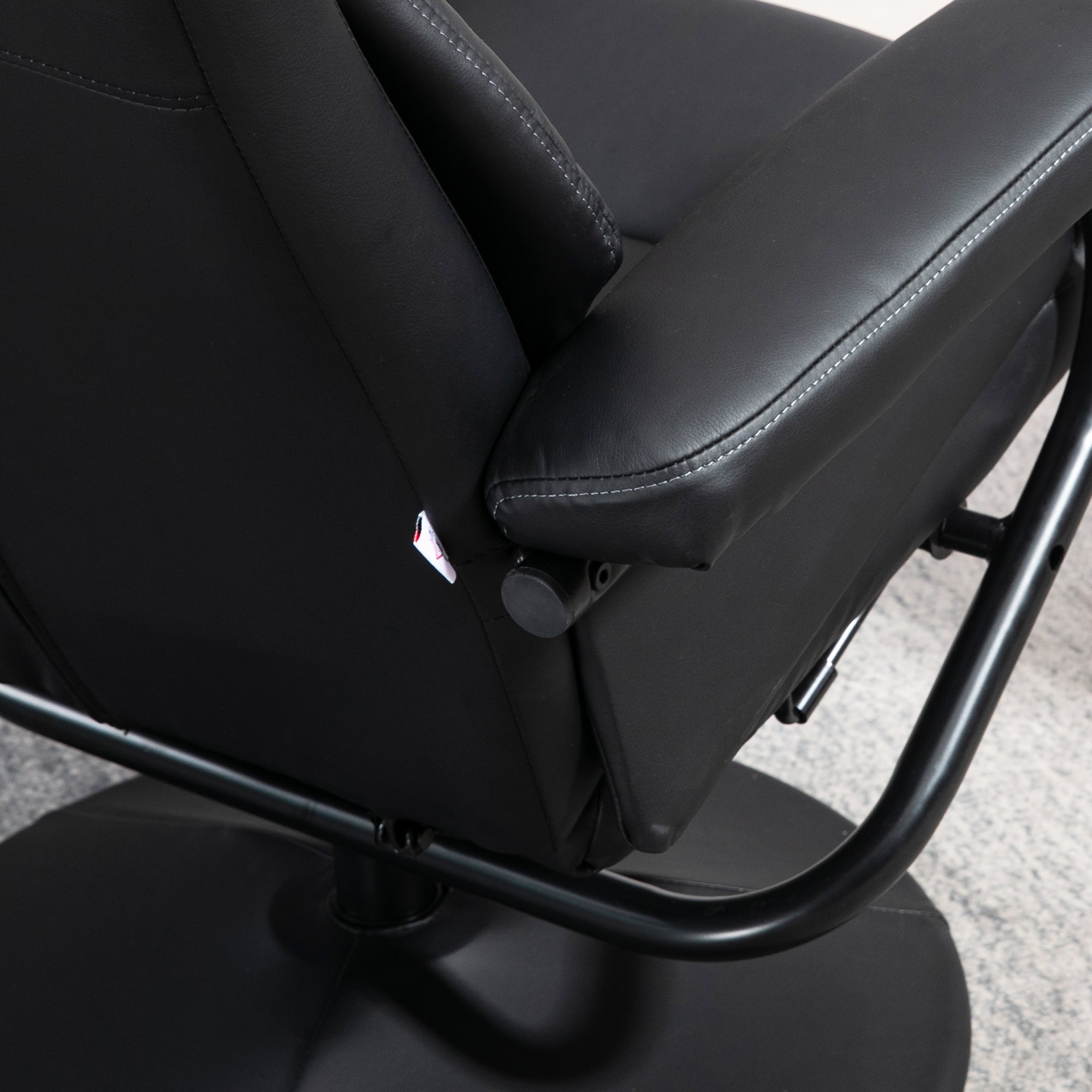 Black leather swivel recliner chair with stitched detailing sturdy metal frame perfect for office or living room