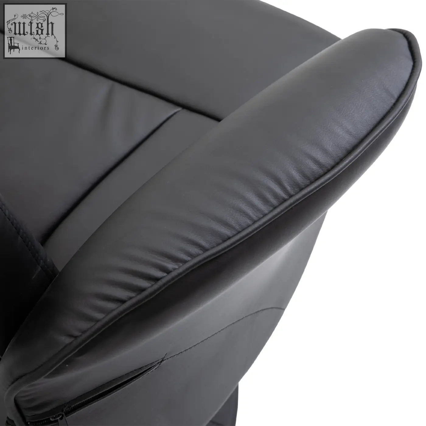 Black faux leather upholstery armrest with stitched seams on homcom swivel recliner chair with footstool