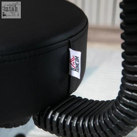 Black leatherette salon chair with padded seat back five wheels height adjustable hose attached for salon use