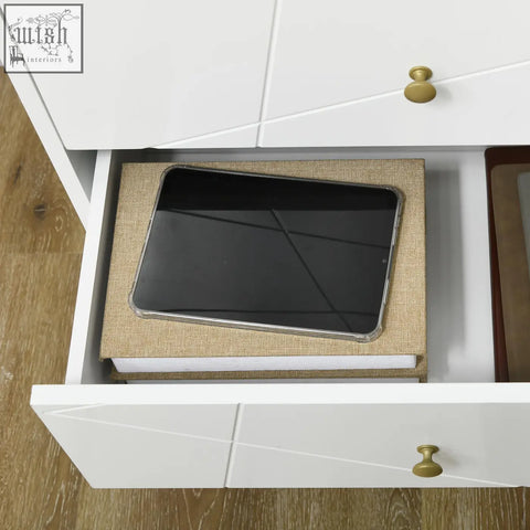 A sleek black tablet in a transparent case inside an open drawer of a clean white homcom dresser with hairpin legs