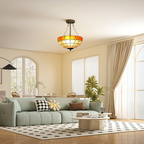 A warm-toned tiffany style ceiling light with brass frame and three e27 bulb sockets for vintage living room lighting