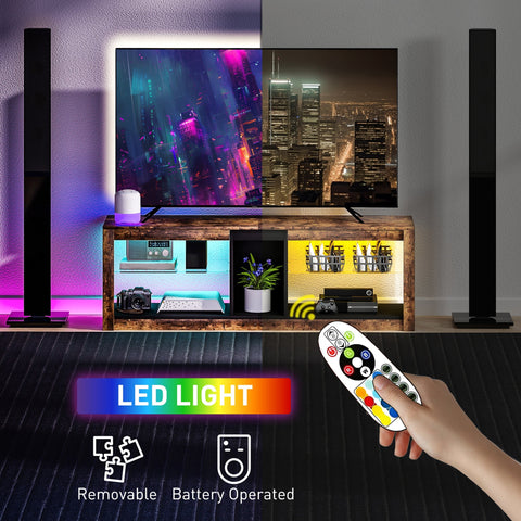 Hand holding a white remote control with colorful buttons for homcom tv stand with removable led light and storage shelves